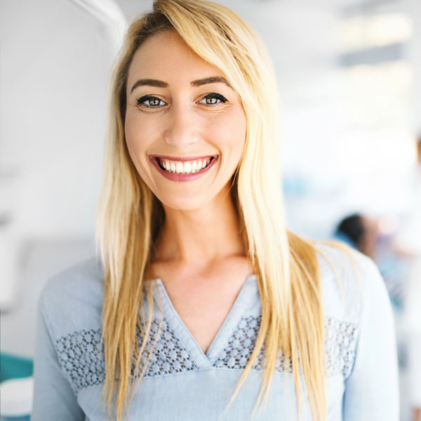 woman in blue shirt smiling