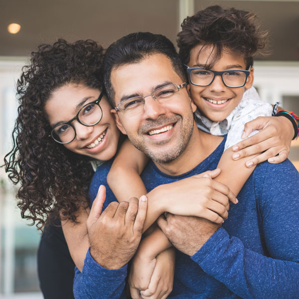 family of three smiling together